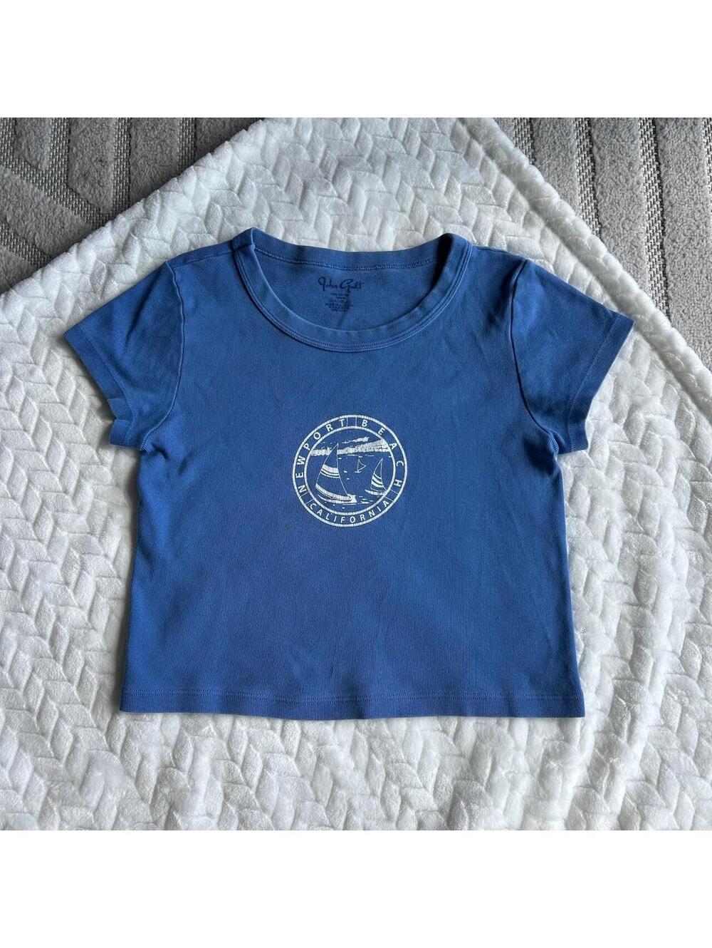 Blue John Galt cotton baby tee with white circular logo featuring a sailboat